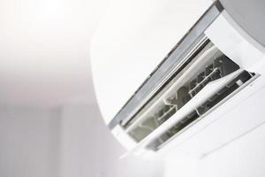 Air conditioner on white wall room interior background photo