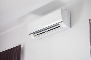 Air conditioner on white wall room interior background photo