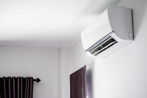 Air conditioner on white wall room interior background photo