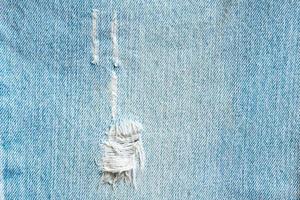 Denim blue jeans torn fashion design texture close up background top view photo