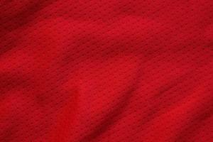 Red sports clothing fabric football shirt jersey texture close up photo