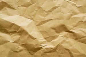Brown crumpled paper recycled kraft sheet texture background photo
