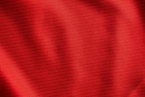 Red sports clothing fabric football jersey texture close up photo