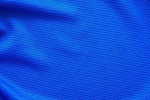 Blue football jersey clothing fabric texture sports wear background, close up top view photo