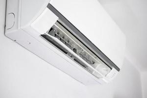 Air conditioner on white wall room interior background photo