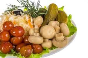 Marinated vegetables on white photo