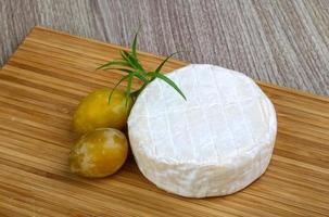 Brie cheese on table photo