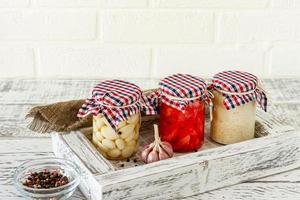 Glass jar with canned garlic, ginger and horseradish. Fermented food on a white background photo