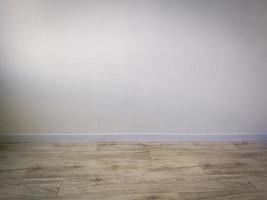 Empty room interior - white wall and wooden floor photo