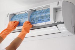 Asian man hand hold air conditioner filter cleaning concept photo