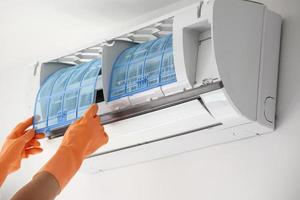 Asian man hand hold air conditioner filter cleaning concept photo