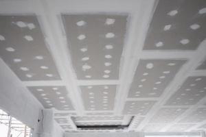 ceiling gypsum board installation at construction site photo