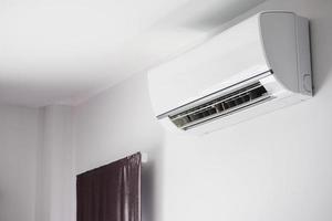 Air conditioner on white wall room interior background photo