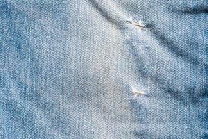 Denim blue jeans torn fashion design texture close up background top view photo