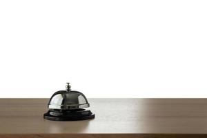Hotel service bell on wood counter isolated on white background photo