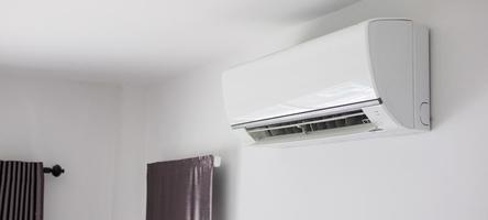 Air conditioner on white wall room interior background photo