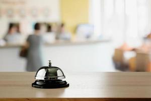 Hotel service bell on wood counter background photo