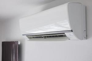 Air conditioner on white wall room interior background photo