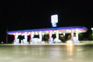 Petrol gas station at night time blurred background with bokeh light photo