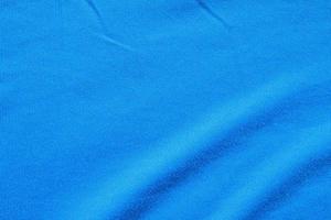 fondo de ropa deportiva de textura de tela de ropa de camiseta de fútbol azul foto