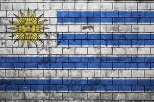 Uruguay flag is painted onto an old brick wall photo