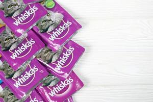 KHARKIV, UKRAINE - FEBRUARY 06, 2021 Whiskas branded cat pet food purple packages close up. Whiskas is a global brand of cat food produced by the American company Mars photo