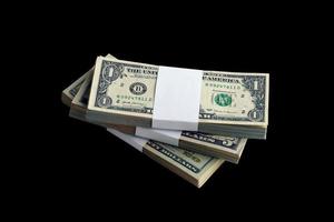 Bundle of US dollar bills isolated on black. Pack of american money with high resolution on perfect black background photo