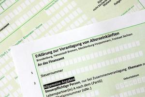 German statement on the assessment of retirement income close up. The concept of taxation and accountant paperwork Germany photo