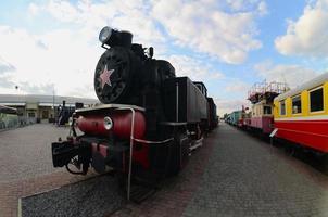 Photo of old black steam locomotives of the Soviet Union. Strong distortion from the fisheye lens