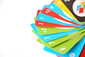 TERNOPIL, UKRAINE - MAY 15, 2022 Many colorful UNO game cards on white background. UNO is an American shedding-type card game that is played with a specially printed deck photo