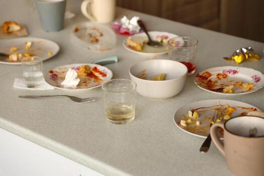 Empty dirty plates with spoons and forks on the table after meal. Banquet ending concept. Unwashed dishes photo
