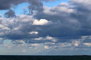 Large rain clouds in the sky over the sea. photo