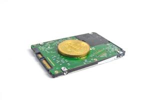 Computer hard drive and bitcoin crypto isolated on white background photo