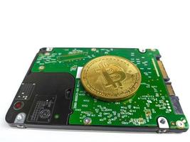 Computer hard drive and bitcoin crypto isolated on white background photo