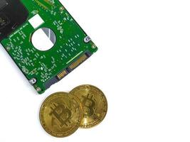 Computer hard drive and bitcoin crypto isolated on white background photo