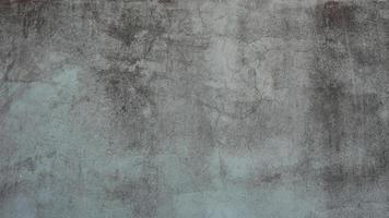 The old cement wall was weathered, the surface was scratched, the surface was scratched and damaged. For a mysterious retro-conservative background. photo