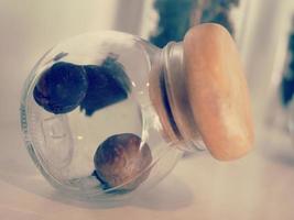 The plant seeds are well kept in a beautiful glass jar. photo