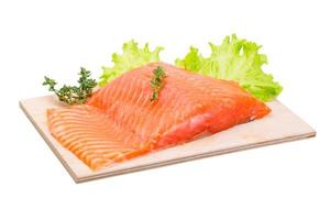 Salmon fillet on wooden board and white background photo