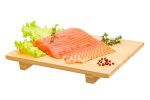 Salmon fillet on wooden board and white background photo