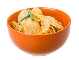 Potato chips in a bowl on white background photo