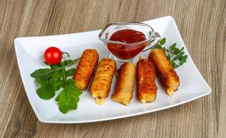 Cheese sticks on wood photo