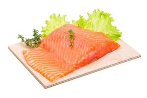 Salmon fillet on wooden board and white background photo