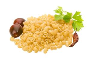 Raw macaroni on white background photo