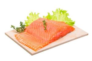 Salmon fillet on wooden board and white background photo