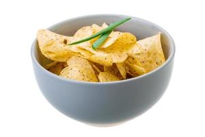 Potato chips in a bowl on white background