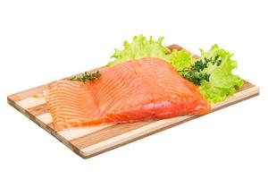 Salmon fillet on wooden board and white background photo