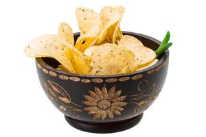 Potato chips in a bowl on white background photo