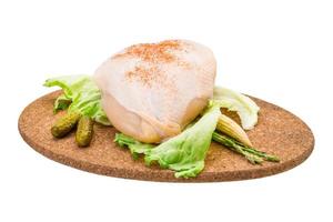 Chicken breast on wooden board and white background photo