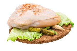 Chicken breast on wooden board and white background photo