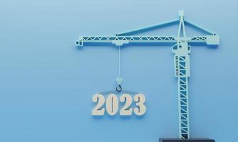 2023 Número 3d en una grúa sobre fondo azul, feliz año nuevo 2023 para un sitio de construcción, visión para el próximo año de fondo. ilustración de renderizado 3d. foto